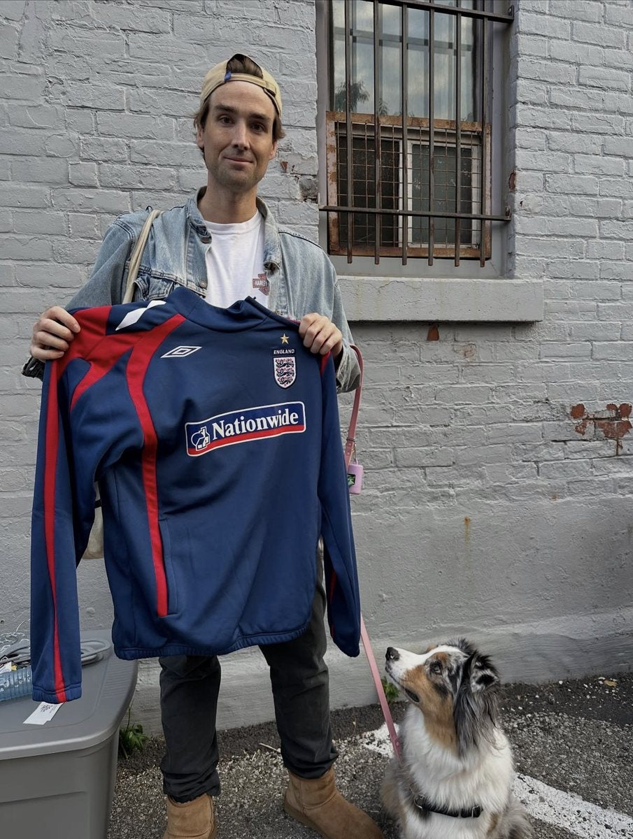 A customer and his dog with a Brazil number 10 shirt